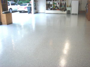 After Brooklyn Auto Shop floor repair image with door open and light shining into the shop