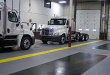 Thumbnail - auto shop after supratile is installed - grey, black, yellow flooring with trucks